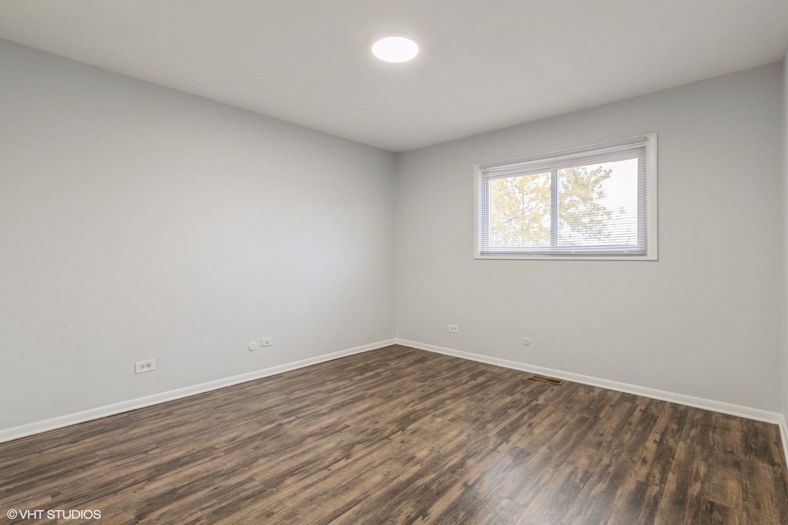 9349 Dee Road Des Plaines, IL 60016 - Photo 15 of 22 an empty room with wooden floor and windows