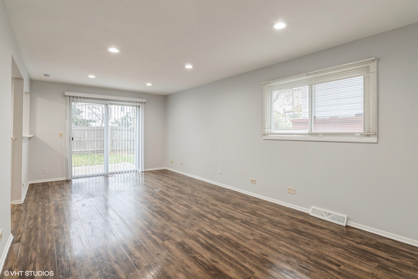 9349 Dee Road Des Plaines, IL 60016 - Photo 2 of 22 an empty room with wooden floor and windows