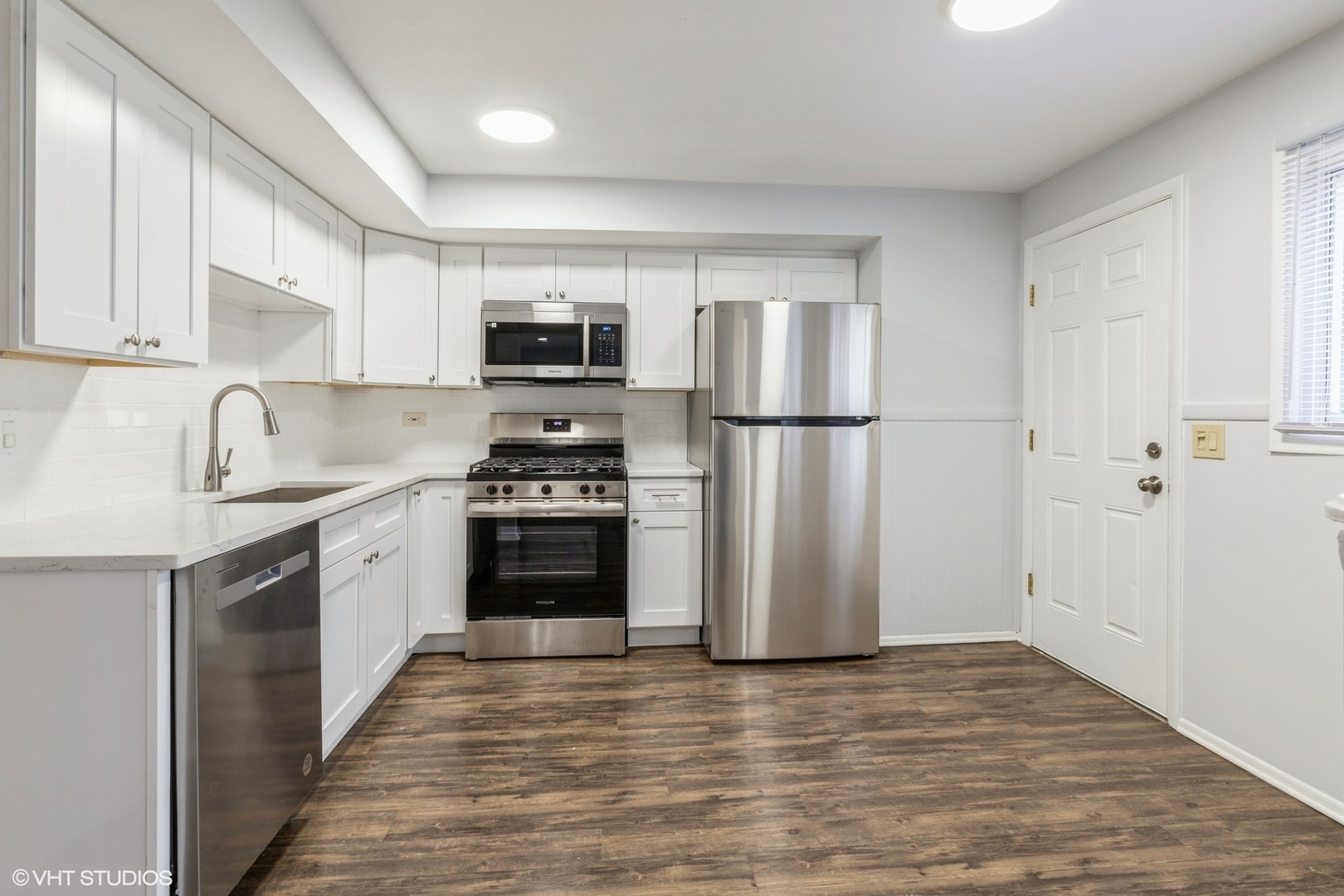 9349 Dee Road Des Plaines, IL 60016 - Photo 5 of 22 a kitchen with a refrigerator a stove top oven a sink and dishwasher