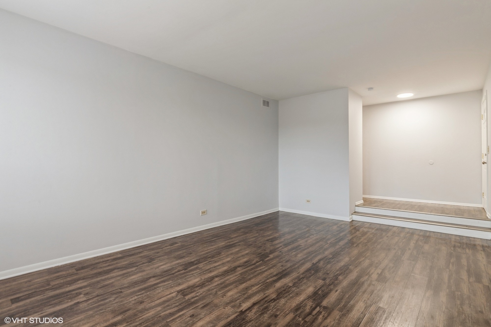 9349 Dee Road Des Plaines, IL 60016 - Photo 7 of 22 a view of an empty room with wooden floor