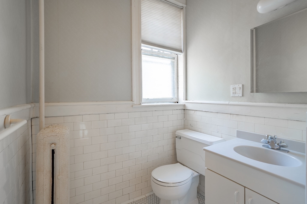 12 Gibbs Street, Unit 2 Brookline, MA 02446 - Photo 12 of 21 a bathroom with a toilet sink and mirror