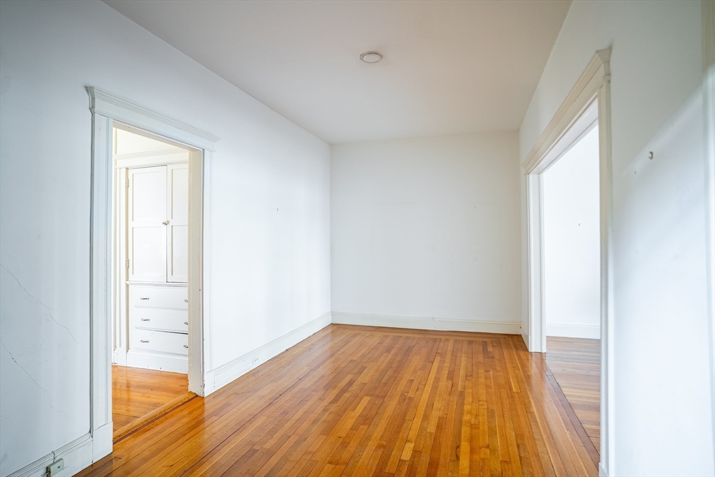 12 Gibbs Street, Unit 2 Brookline, MA 02446 - Photo 17 of 21 a view of a room with wooden floor