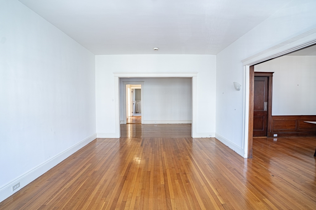 12 Gibbs Street, Unit 2 Brookline, MA 02446 - Photo 3 of 21 a view of empty room with wooden floor