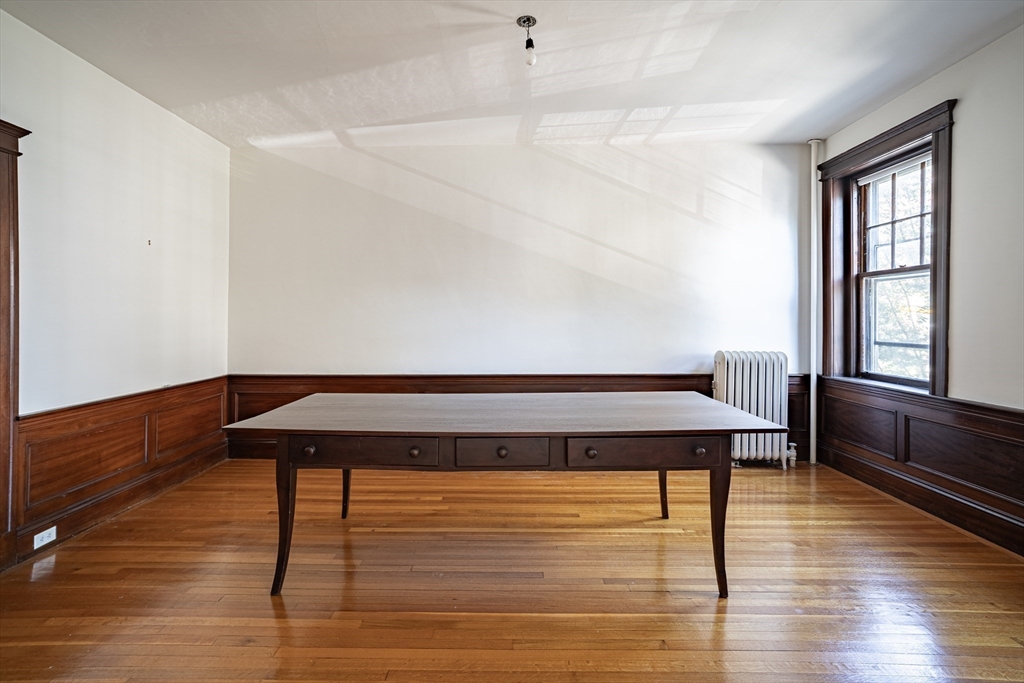 12 Gibbs Street, Unit 2 Brookline, MA 02446 - Photo 6 of 21 a room with wooden floor and window