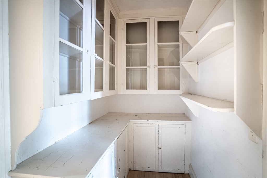 12 Gibbs Street, Unit 2 Brookline, MA 02446 - Photo 8 of 21 a view of an empty room with wooden floor and a window