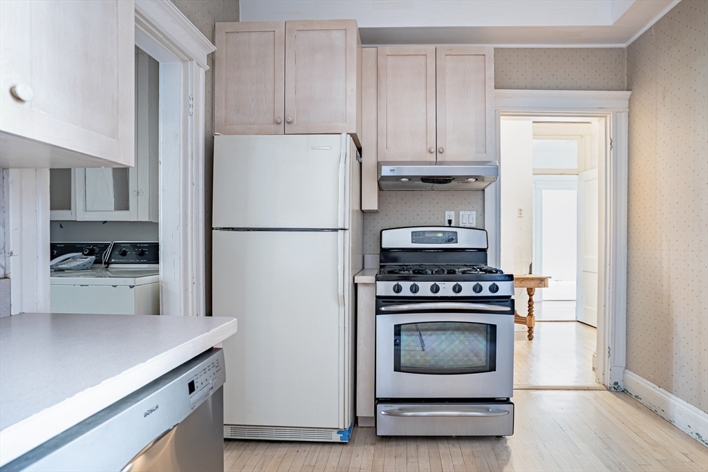 12 Gibbs Street, Unit 2 Brookline, MA 02446 - Photo 10 of 21 a kitchen with a stove and a refrigerator