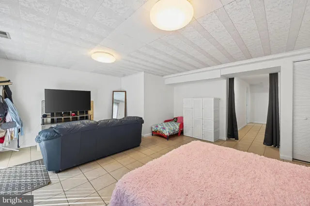 a bedroom with furniture and a flat screen tv