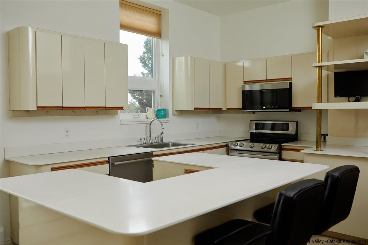 27 Westview Drive Wallkill, NY 12589 - Photo 13 of 35 a kitchen with a sink a microwave a stove and cabinets