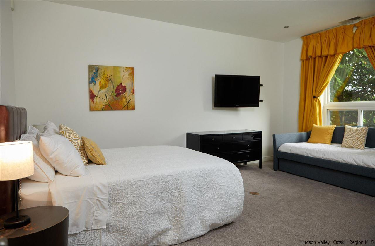 27 Westview Drive Wallkill, NY 12589 - Photo 20 of 35 a bedroom with a bed a couch and a flat screen tv