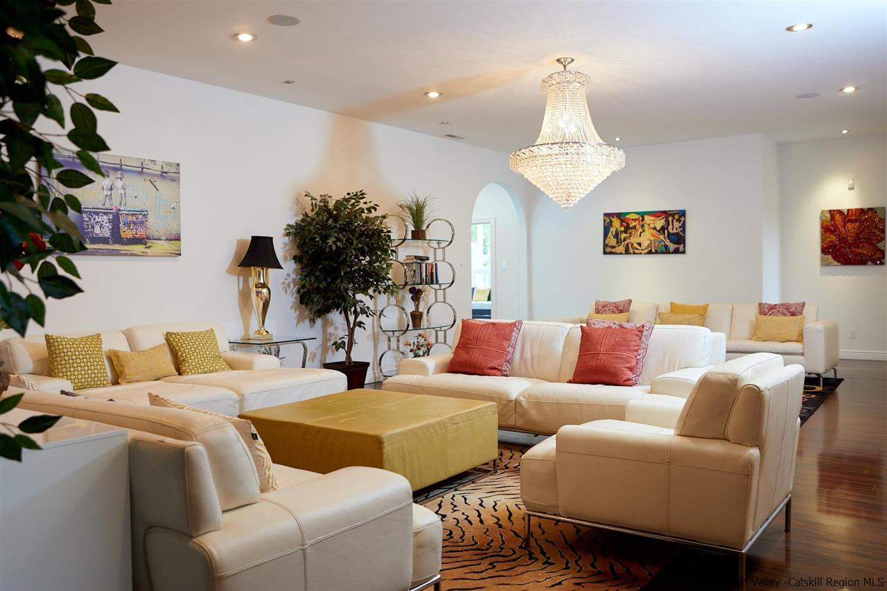 27 Westview Drive Wallkill, NY 12589 - Photo 3 of 35 a living room with furniture potted plant and a chandelier
