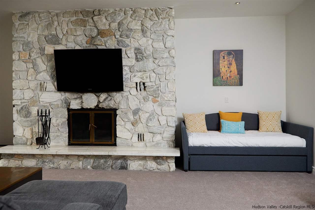 27 Westview Drive Wallkill, NY 12589 - Photo 8 of 35 a living room with fireplace furniture and a flat screen tv