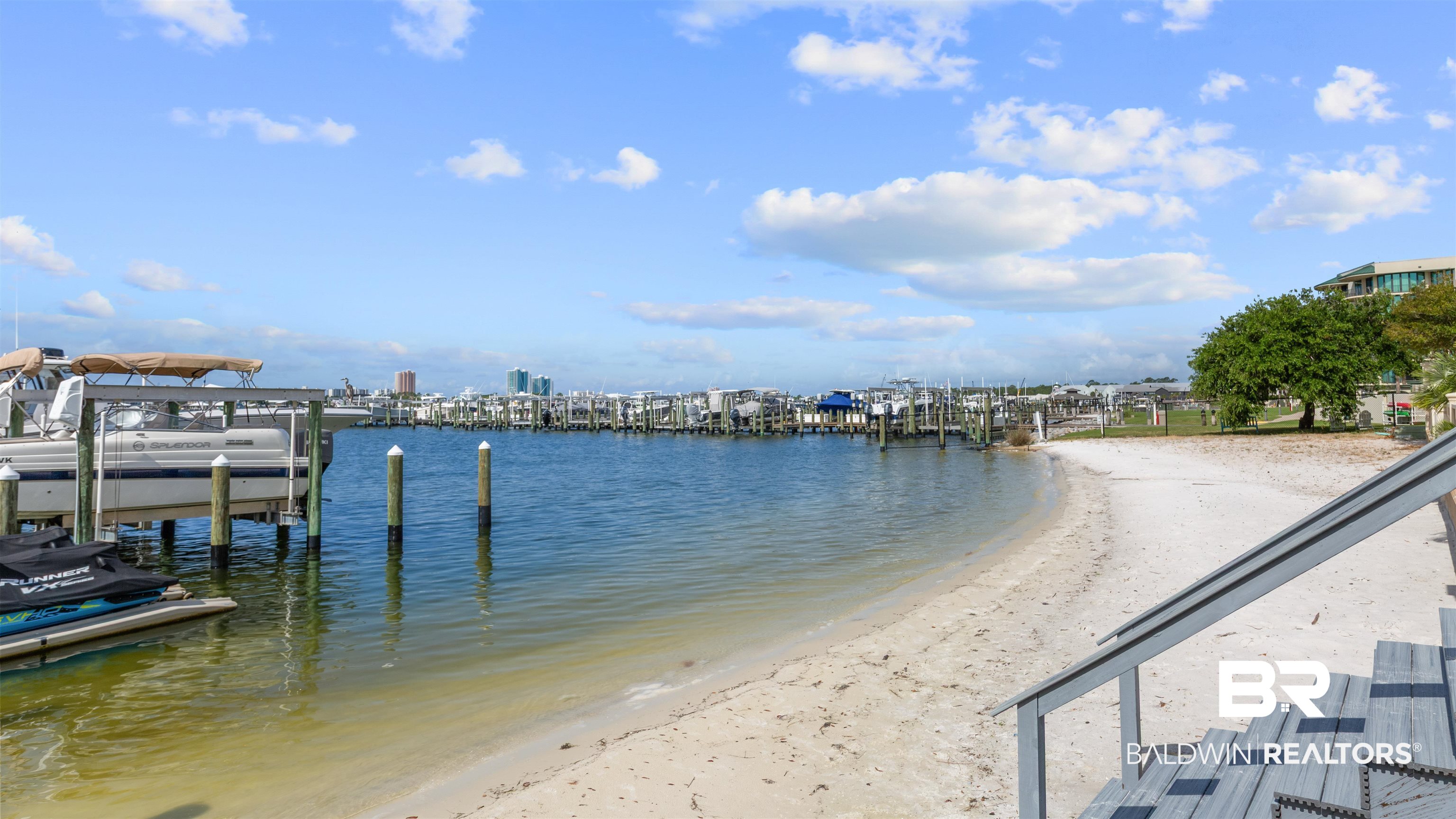 27582 Canal Road, Unit 2207 Orange Beach, AL 36561 - Photo 22 of 25 Dock area with view of water and beach