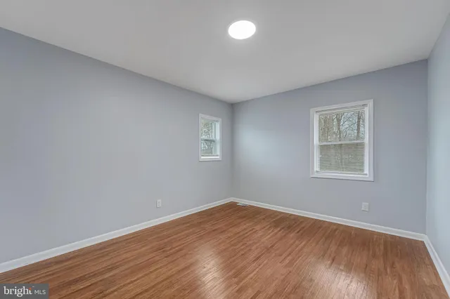 a view of a room with wooden floor and window