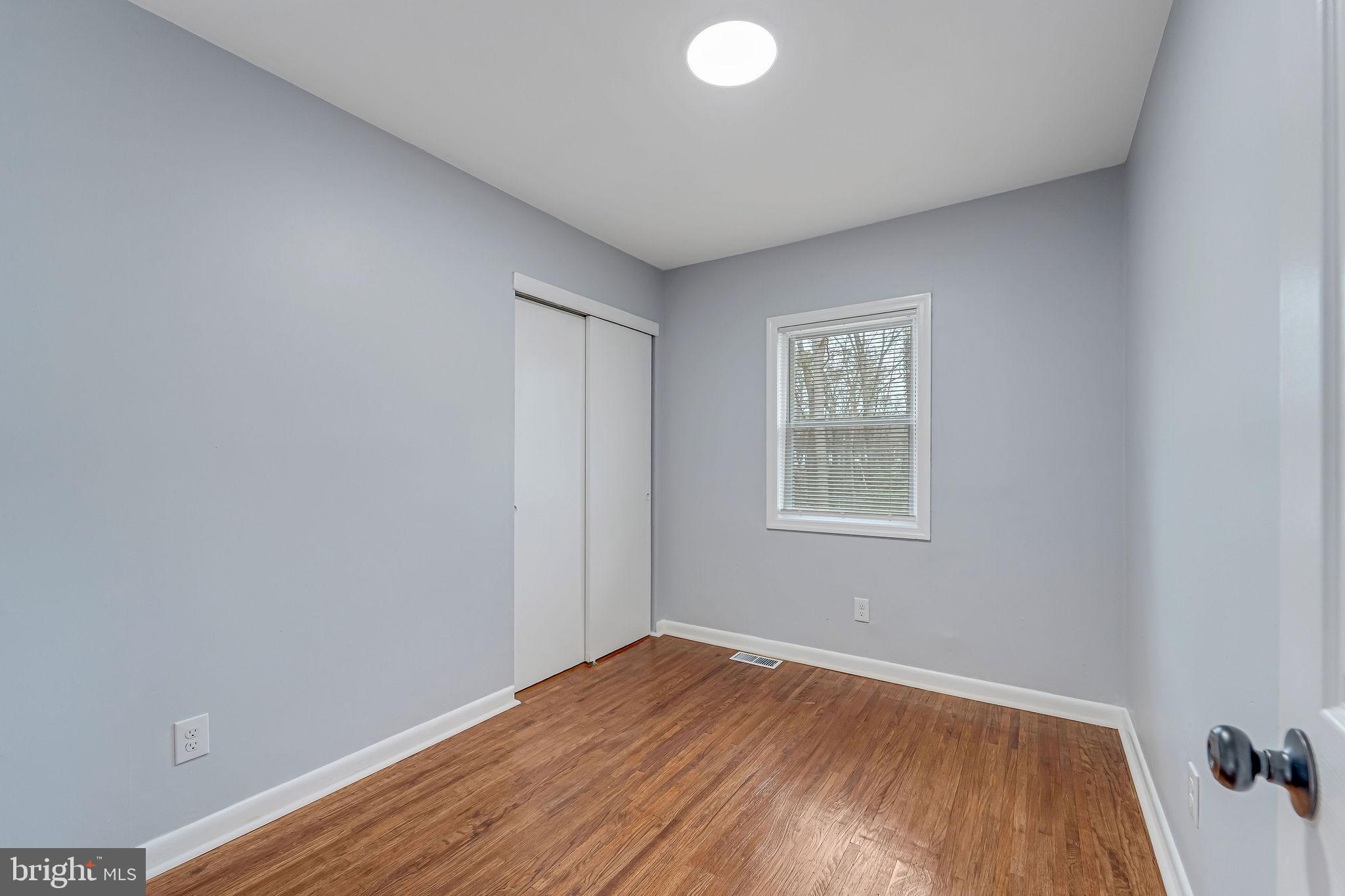 2405 North Cuthbert Drive Lindenwold, NJ 08021 - Photo 16 of 31 a view of an empty room with wooden floor and a window