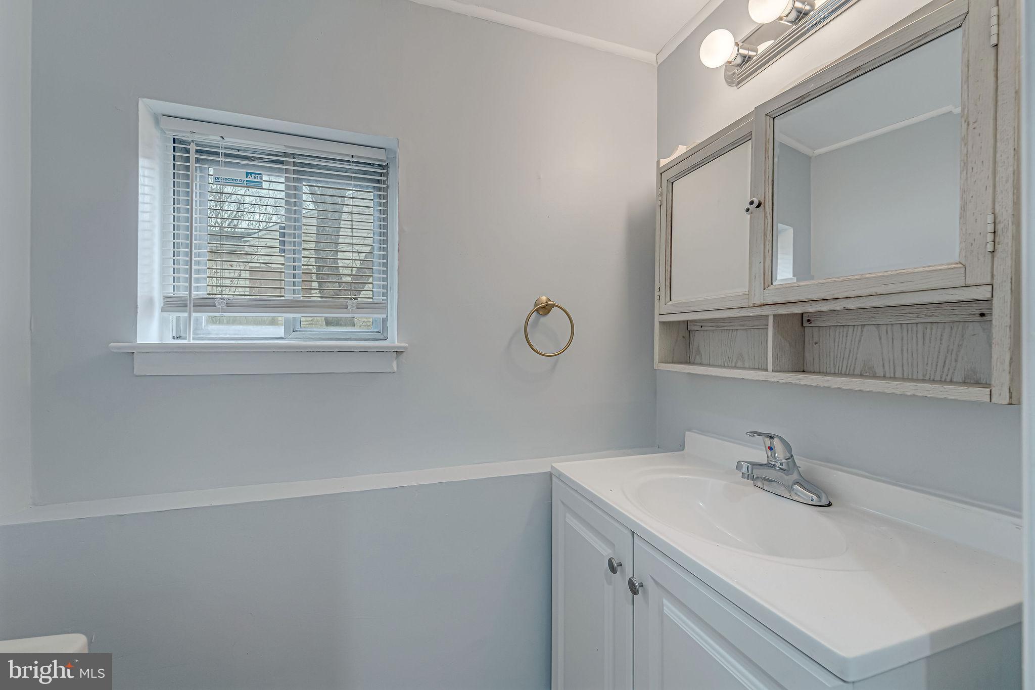 2405 North Cuthbert Drive Lindenwold, NJ 08021 - Photo 22 of 31 a bathroom with a sink and a mirror
