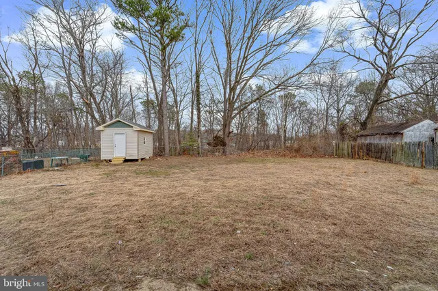 a backyard of house with a trees
