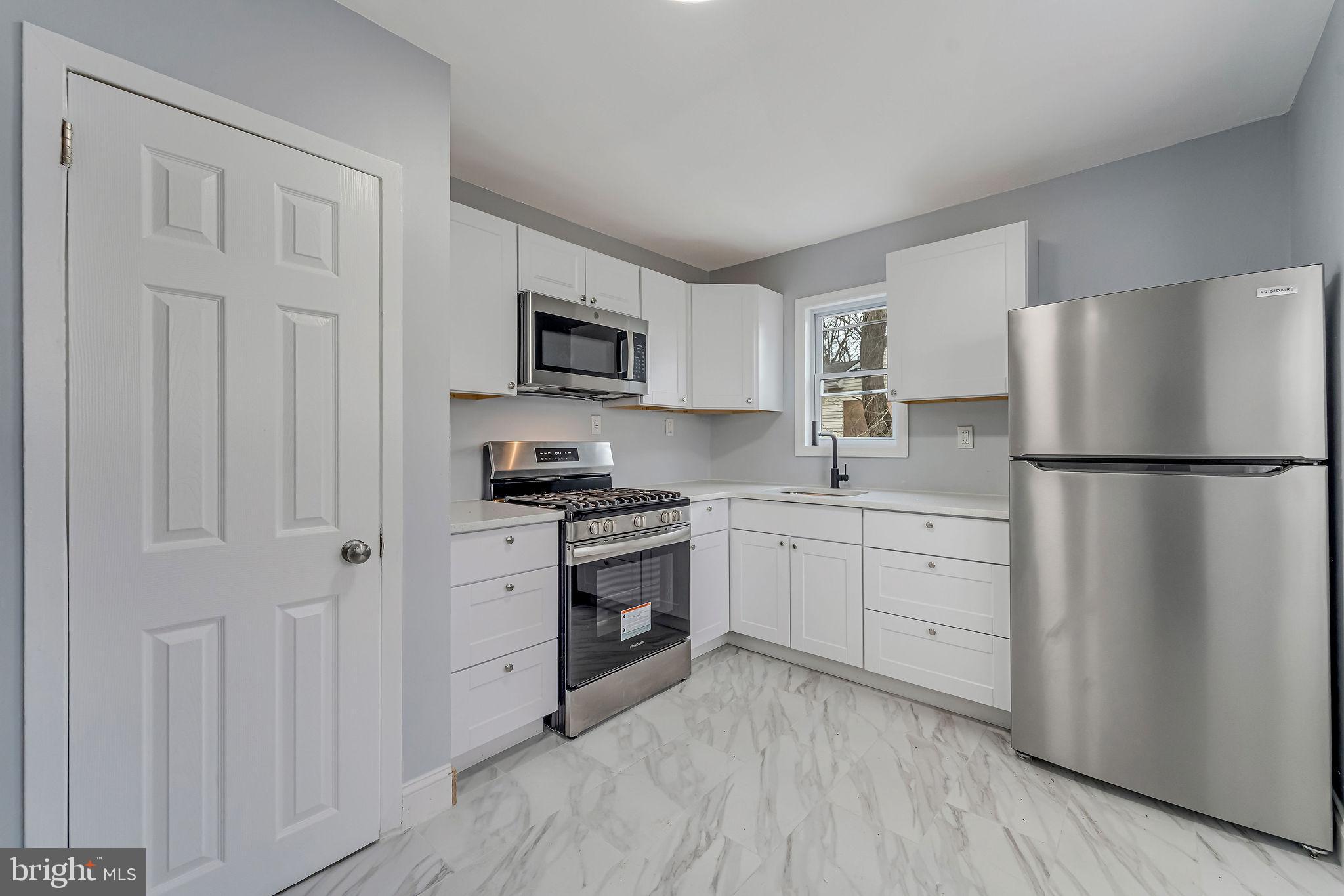 2405 North Cuthbert Drive Lindenwold, NJ 08021 - Photo 7 of 31 a kitchen with cabinets stainless steel appliances and a window