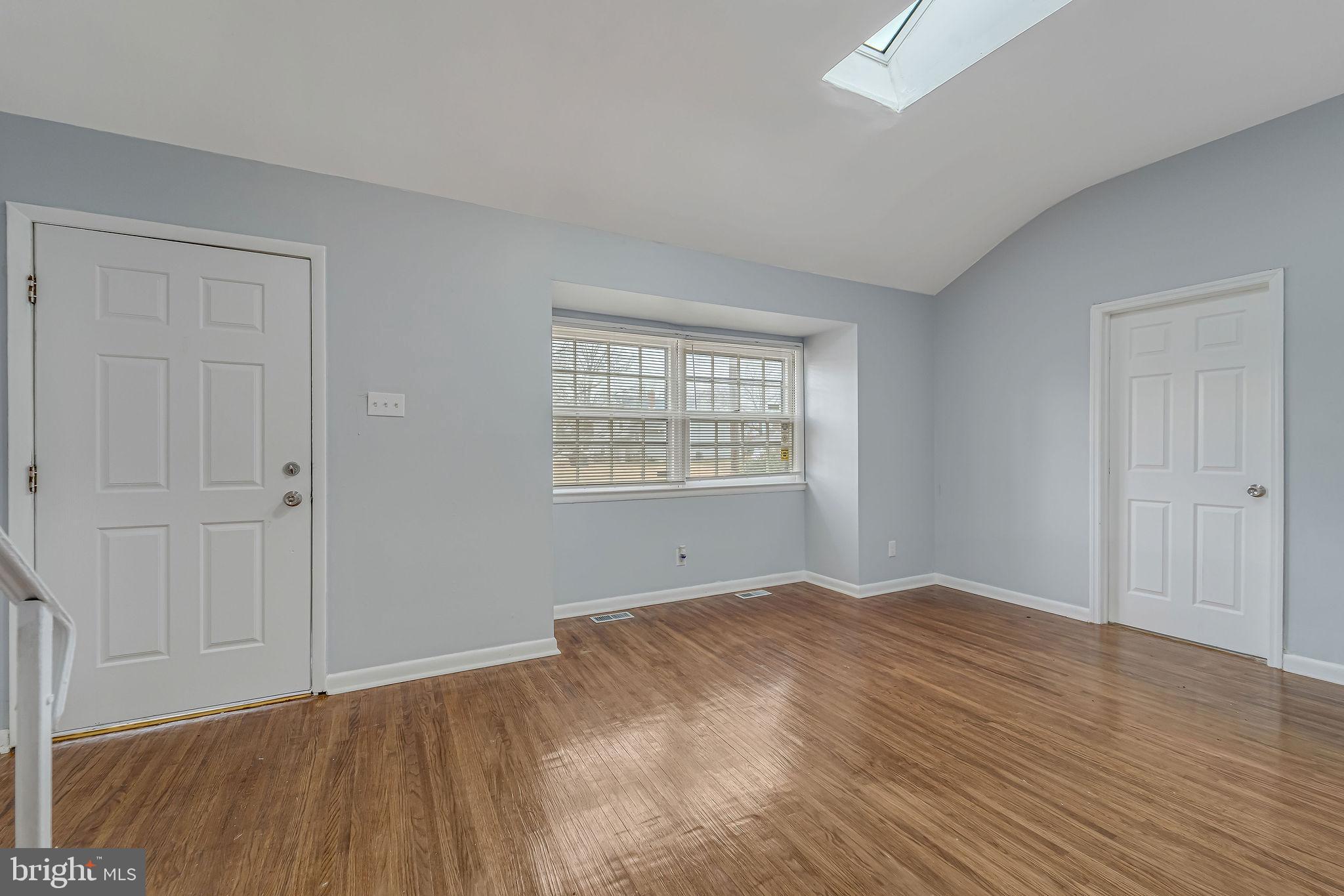 2405 North Cuthbert Drive Lindenwold, NJ 08021 - Photo 9 of 31 a view of an empty room with wooden floor and a window