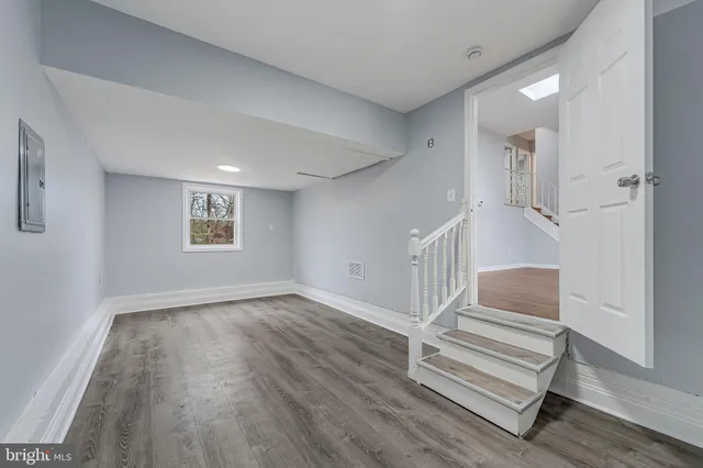 a view of entryway with wooden floor and stairs