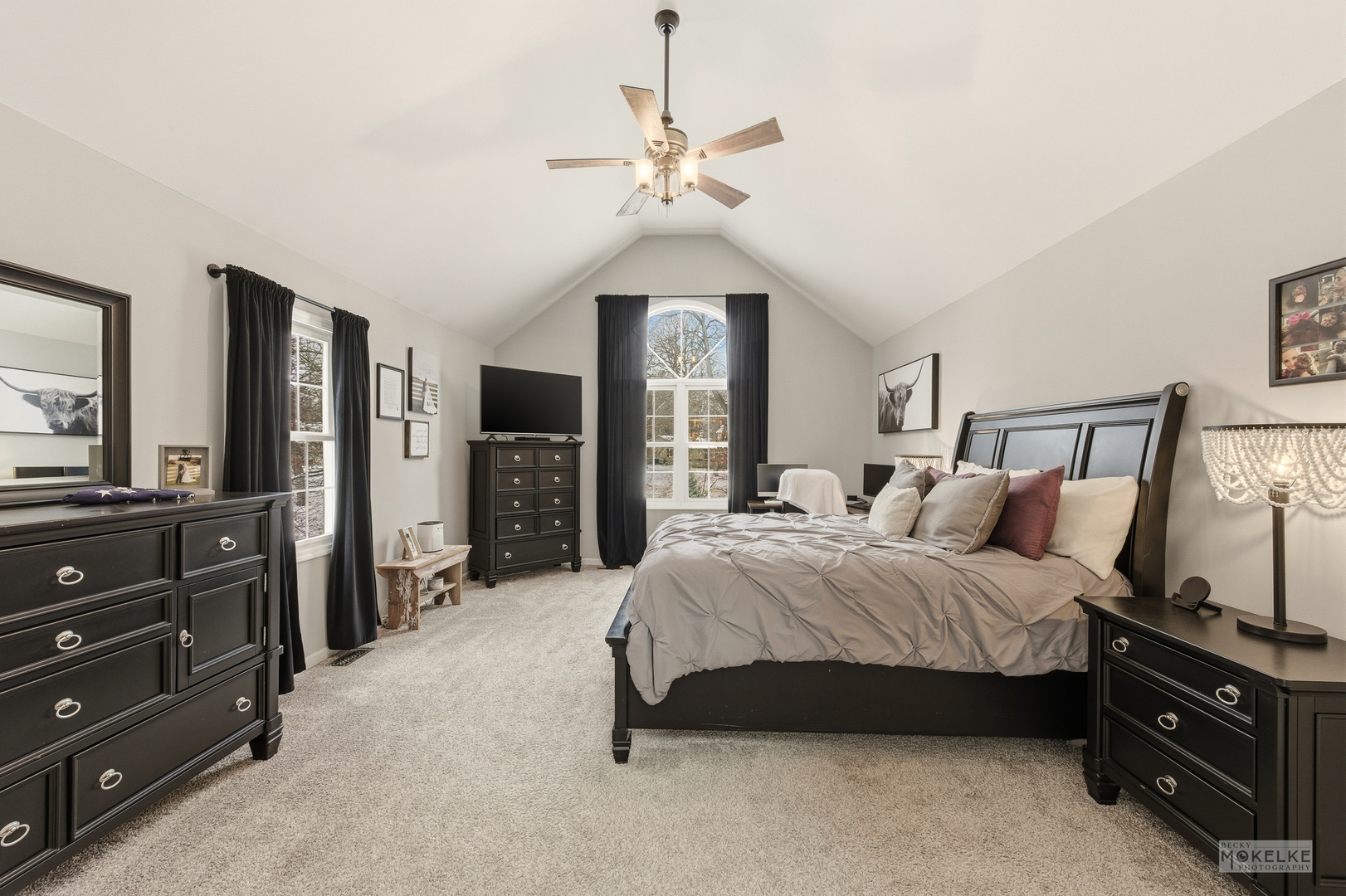 777 Debbie Lane Sandwich, IL 60548 - Photo 19 of 39 a spacious bedroom with a bed a dresser and a chandelier