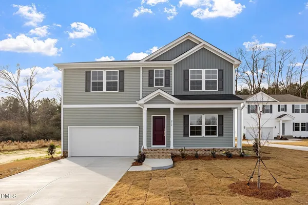 a front view of a house with a yard