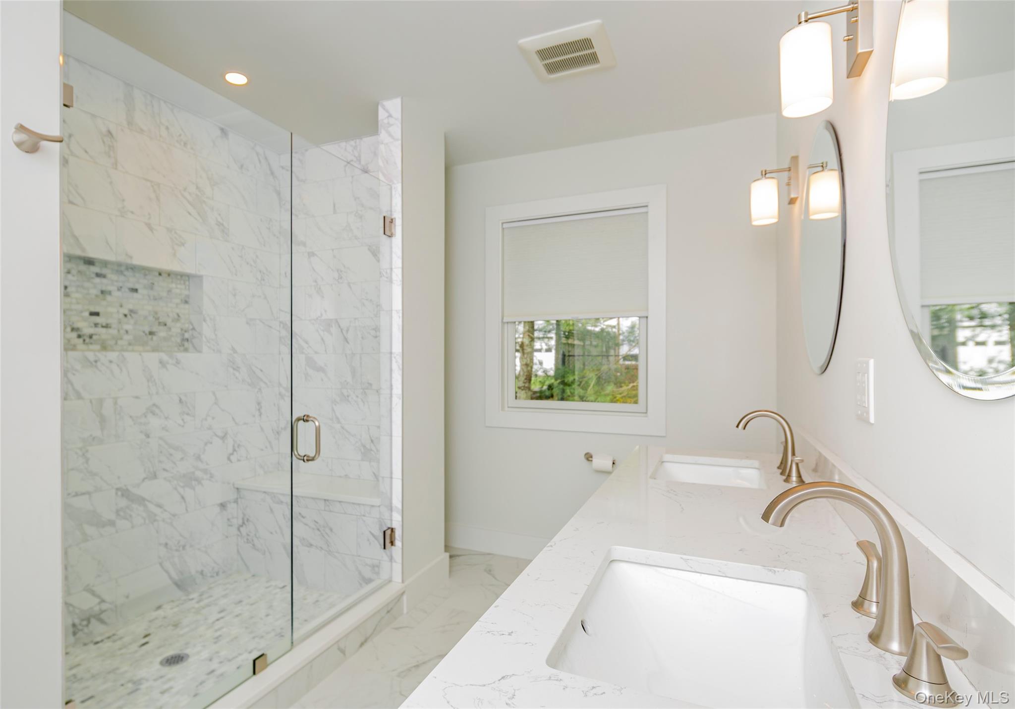 64 Aspatuck Road Westhampton Beach, NY 11978 - Photo 11 of 14 Bathroom featuring light marble finish flooring, a marble finish shower, double vanity, and recessed lighting
