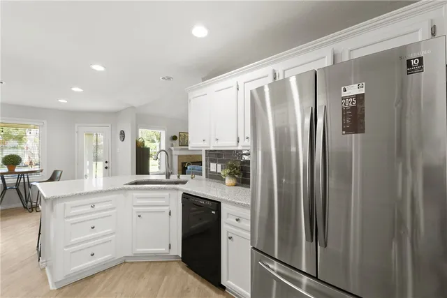 a kitchen with stainless steel appliances a refrigerator sink and cabinets