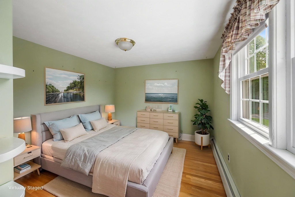 40 Bell Road Weymouth, MA 02188 - Photo 35 of 41 a bedroom with a bed and a painting on the wall