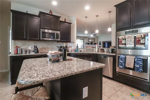 a view of a dining room with furniture and a window
