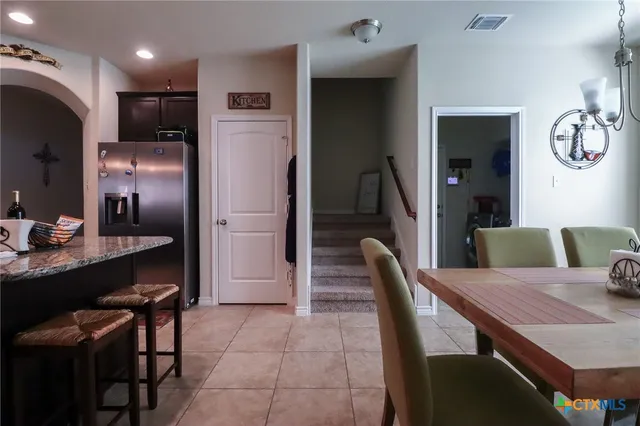 a bedroom with a bed couch and a flat tv screen