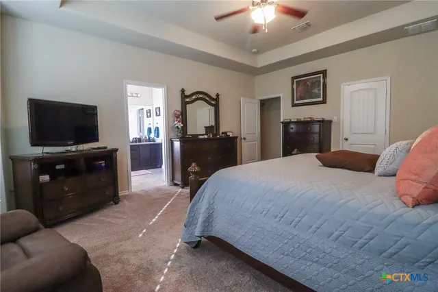 a bedroom with a bed and a dresser