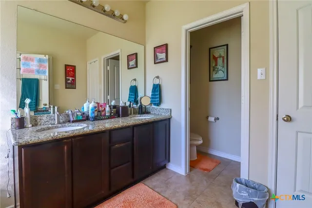 a bathroom with sink granite tub shower and mirror