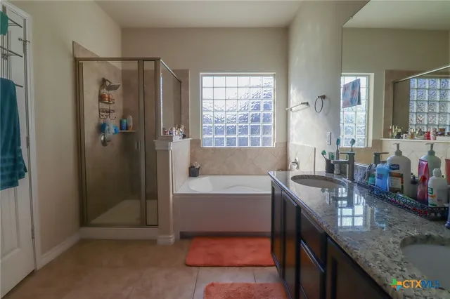 a bedroom with a bed and painting on the wall