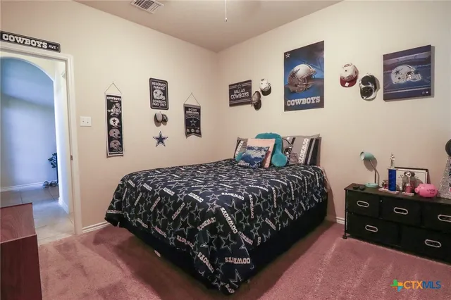 a bedroom with bed and wooden floor