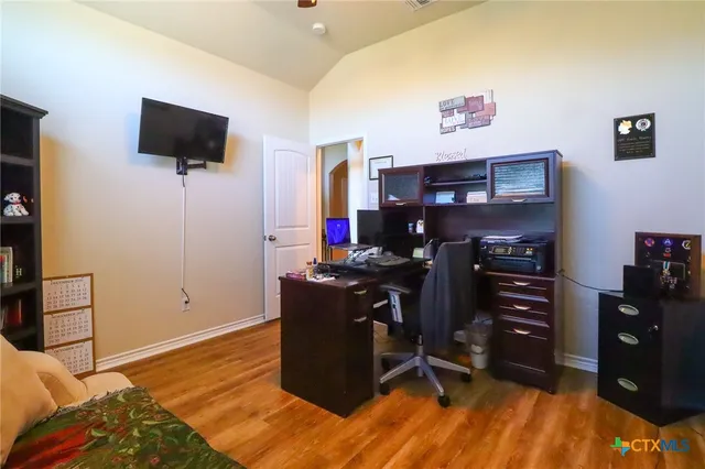 a living room with furniture and a laptop next to a window