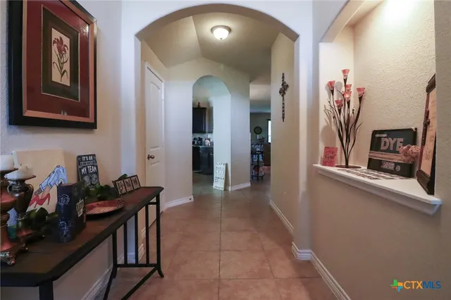 a bedroom with a bed and a dresser with wooden floor