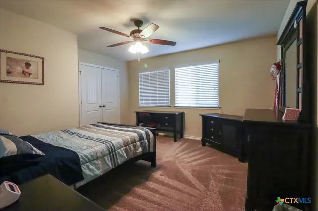 a bathroom with a granite countertop sink and a toilet