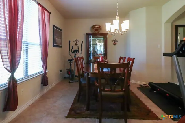 a kitchen with stainless steel appliances granite countertop a refrigerator a sink a stove a microwave and wooden cabinets