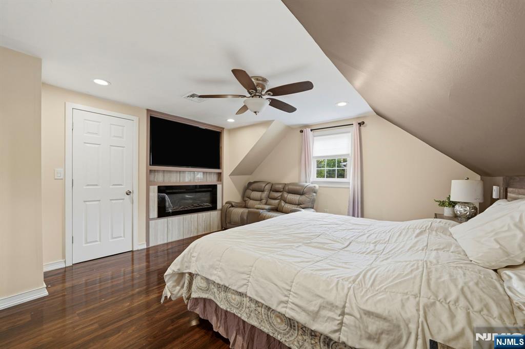 52 Barbara Drive Pompton Lakes, NJ 07442 - Photo 18 of 30 a large bedroom with a bed and a flat screen tv