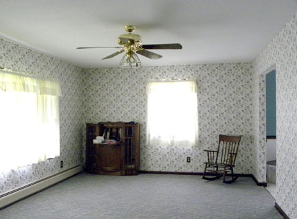 22 Ford Hill Road Rowe, MA 01367 - Photo 8 of 9 a view of an empty room with a fireplace and a window