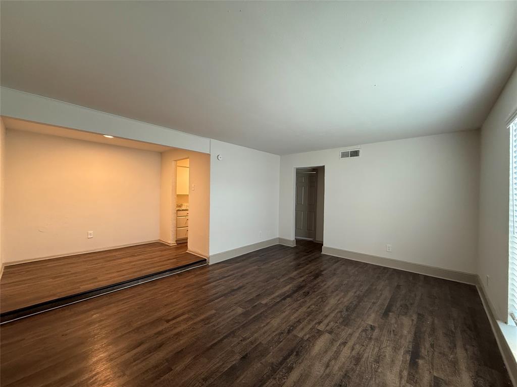 3627 Almazan Drive, Unit 117 Dallas, TX 75220 - Photo 3 of 6 an empty room with wooden floor and windows