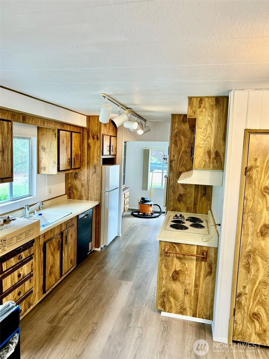 791 Elliot Court Sequim, WA 98382 - Photo 3 of 37 a kitchen with stainless steel appliances a stove a sink wooden cabinets and a dining table