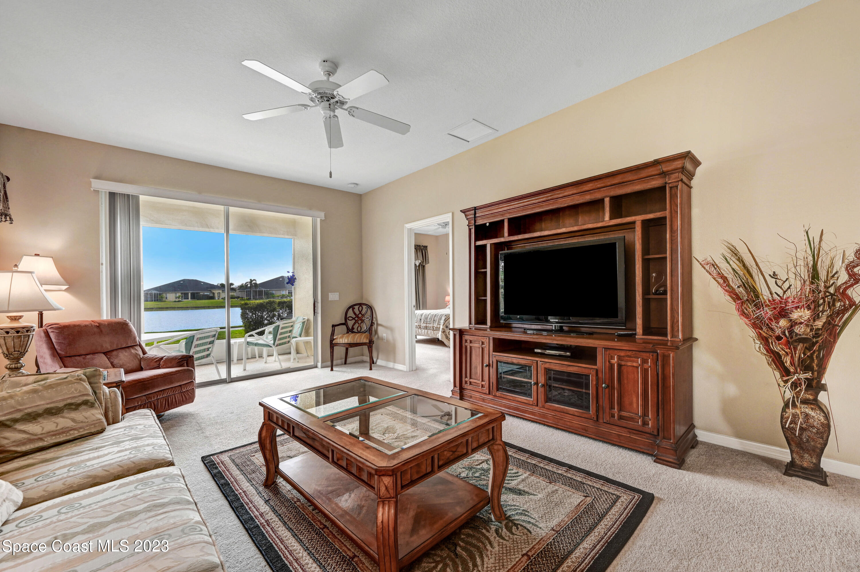 3341 Funston Circle Melbourne, FL 32940 - Photo 12 of 61 a living room with furniture and a flat screen tv