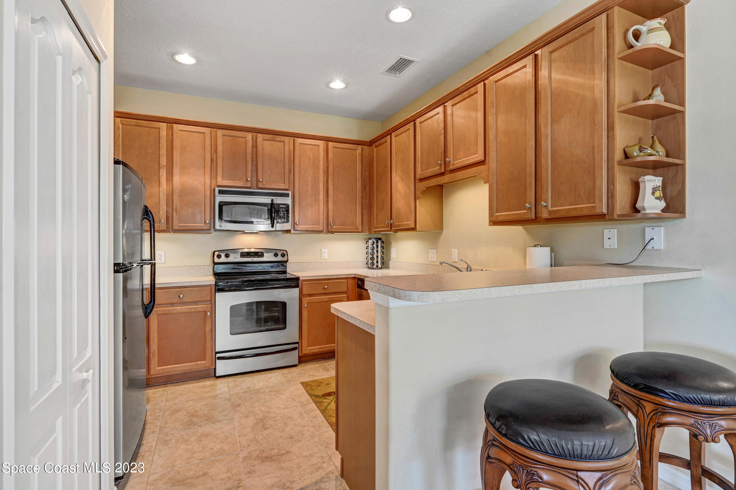 3341 Funston Circle Melbourne, FL 32940 - Photo 15 of 61 a kitchen with a refrigerator stove top oven a sink and dishwasher