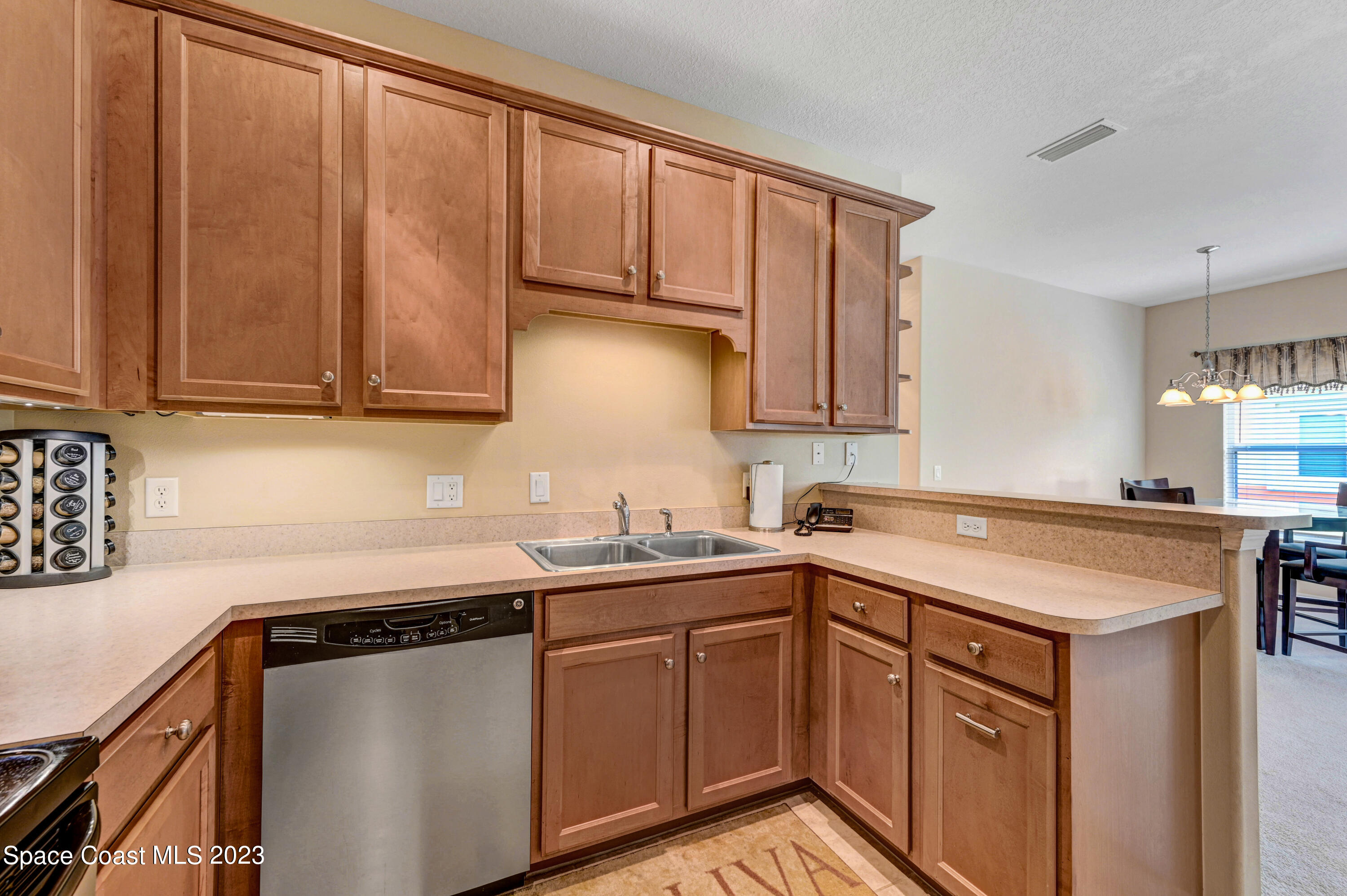 3341 Funston Circle Melbourne, FL 32940 - Photo 17 of 61 a kitchen with stainless steel appliances granite countertop a sink stove and cabinets