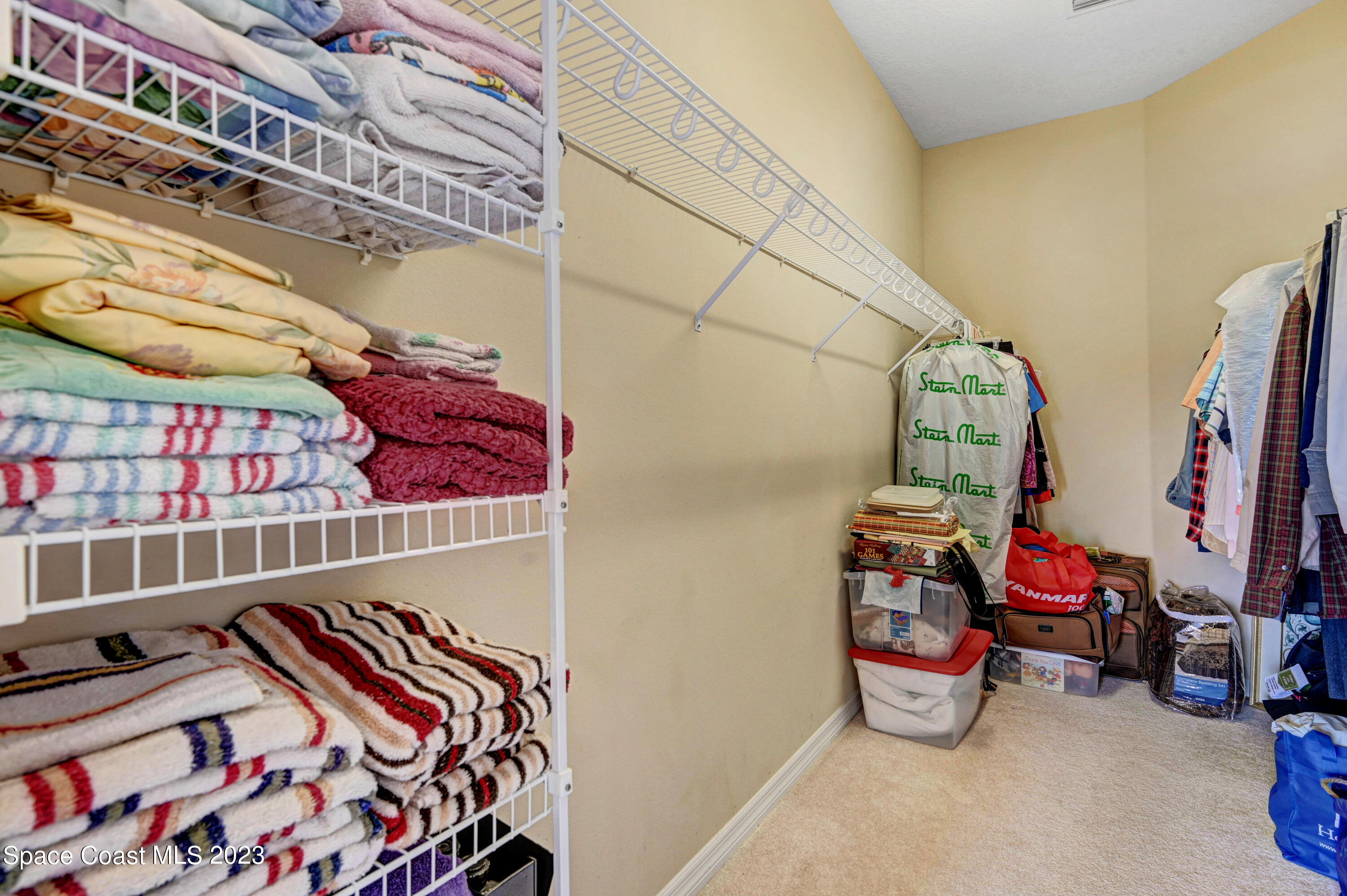 3341 Funston Circle Melbourne, FL 32940 - Photo 22 of 61 a view of walk in closet with clothes and shoes