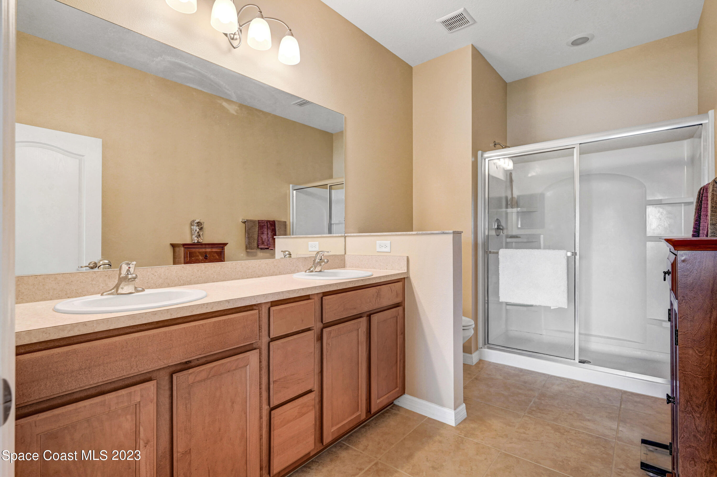 3341 Funston Circle Melbourne, FL 32940 - Photo 23 of 61 a bathroom with a double vanity sink mirror and double