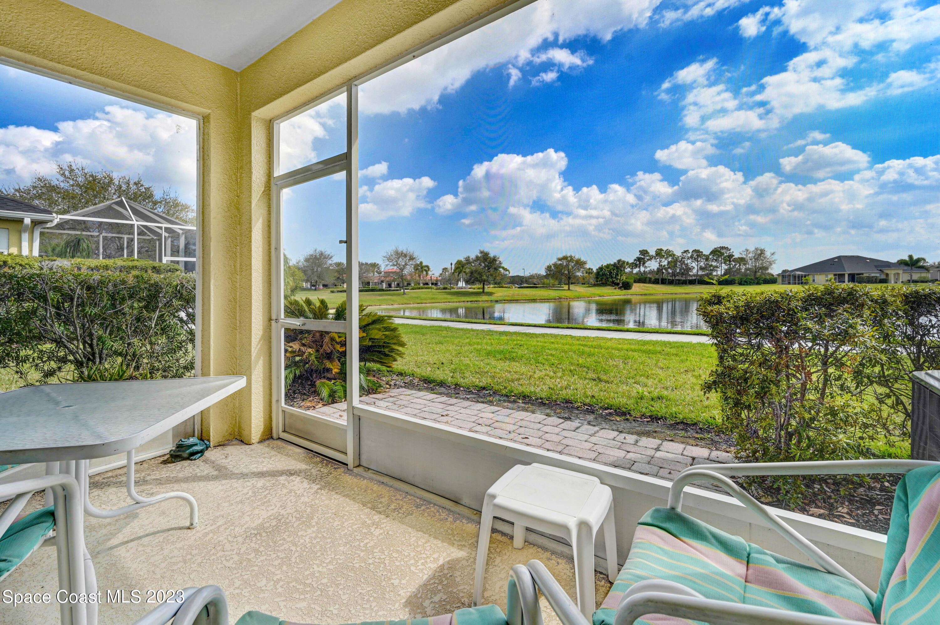 3341 Funston Circle Melbourne, FL 32940 - Photo 28 of 61 a view of a swimming pool with a lawn chairs next to a yard