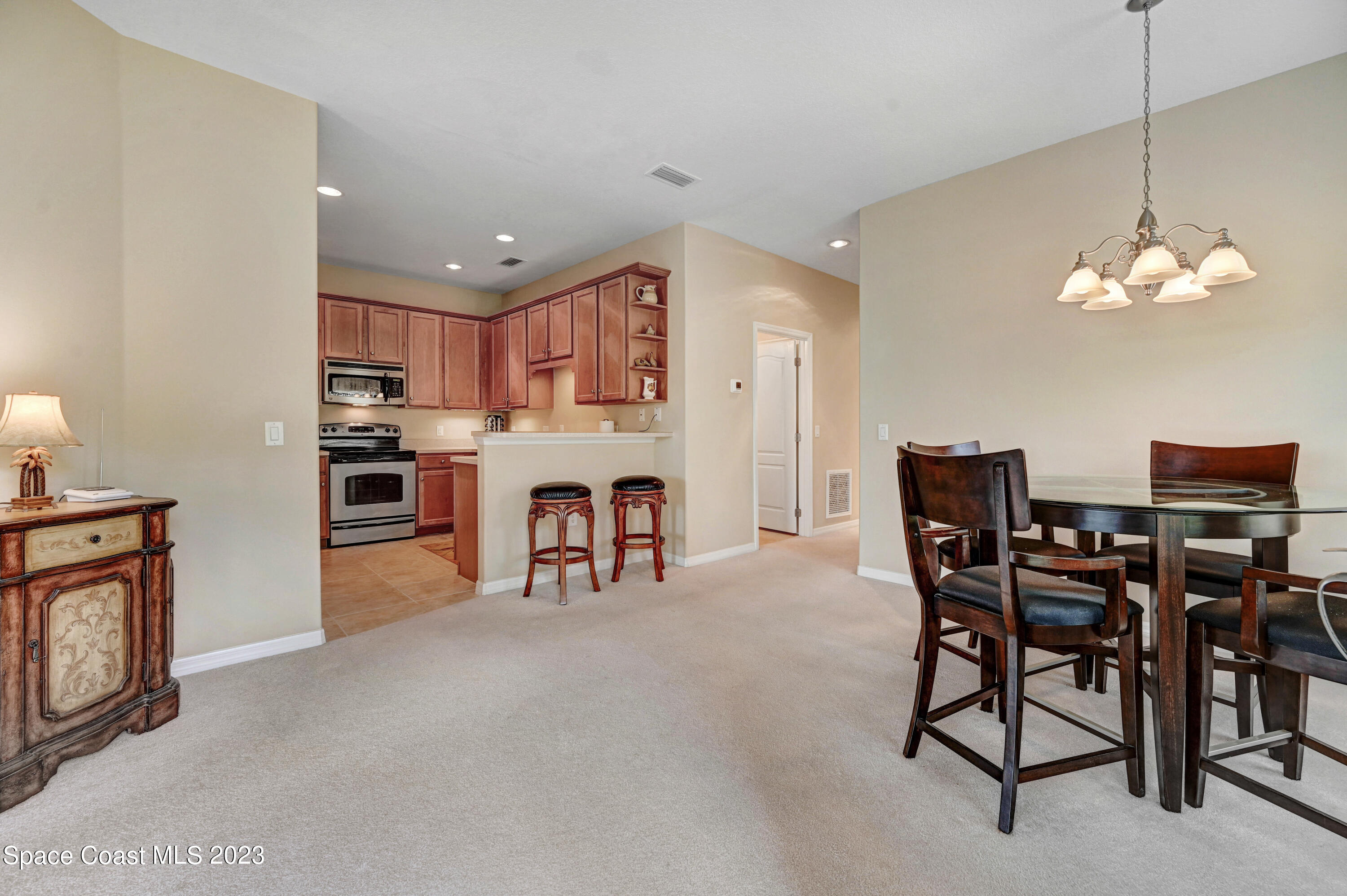 3341 Funston Circle Melbourne, FL 32940 - Photo 6 of 61 a view of a dining room with furniture and a chandelier