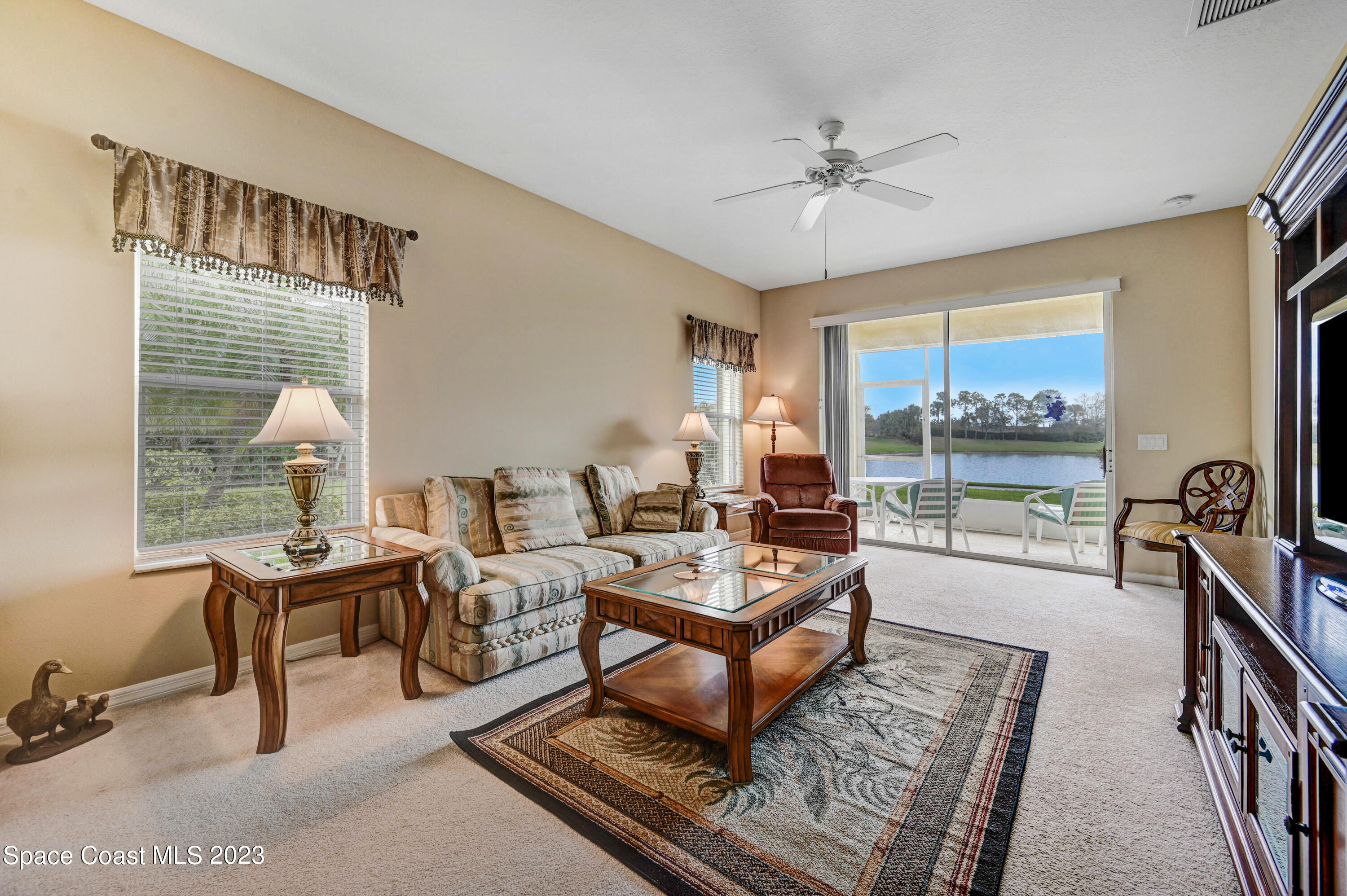 3341 Funston Circle Melbourne, FL 32940 - Photo 9 of 61 a living room with furniture a table and a large window